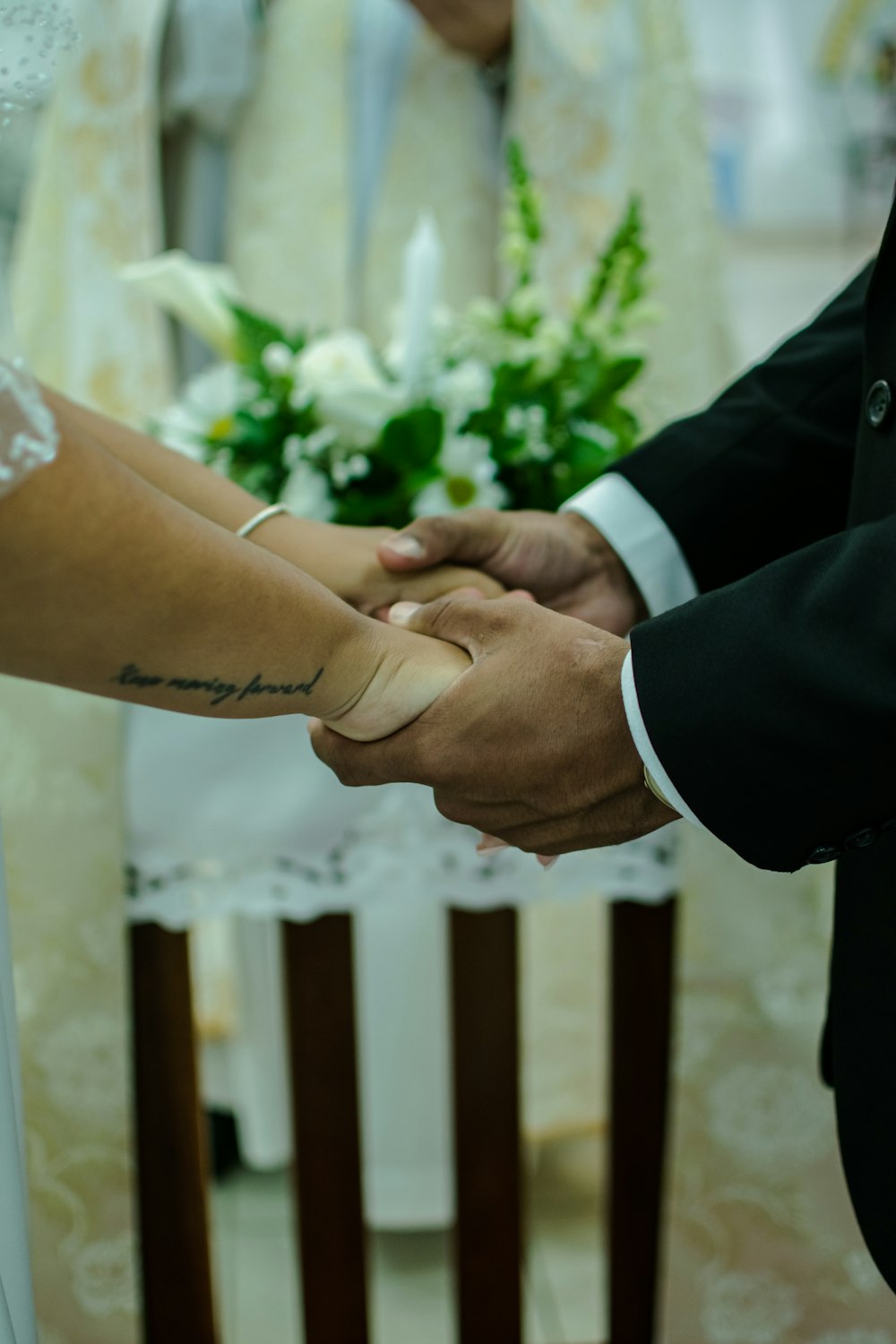 a bride and groom holding hands during a wedding ceremony