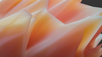 A collection of abstract geometric shapes with sharp edges and a smooth gradient of warm colors, primarily in shades of orange and yellow. The forms create a sense of movement and depth, resembling crumpled or folded paper.