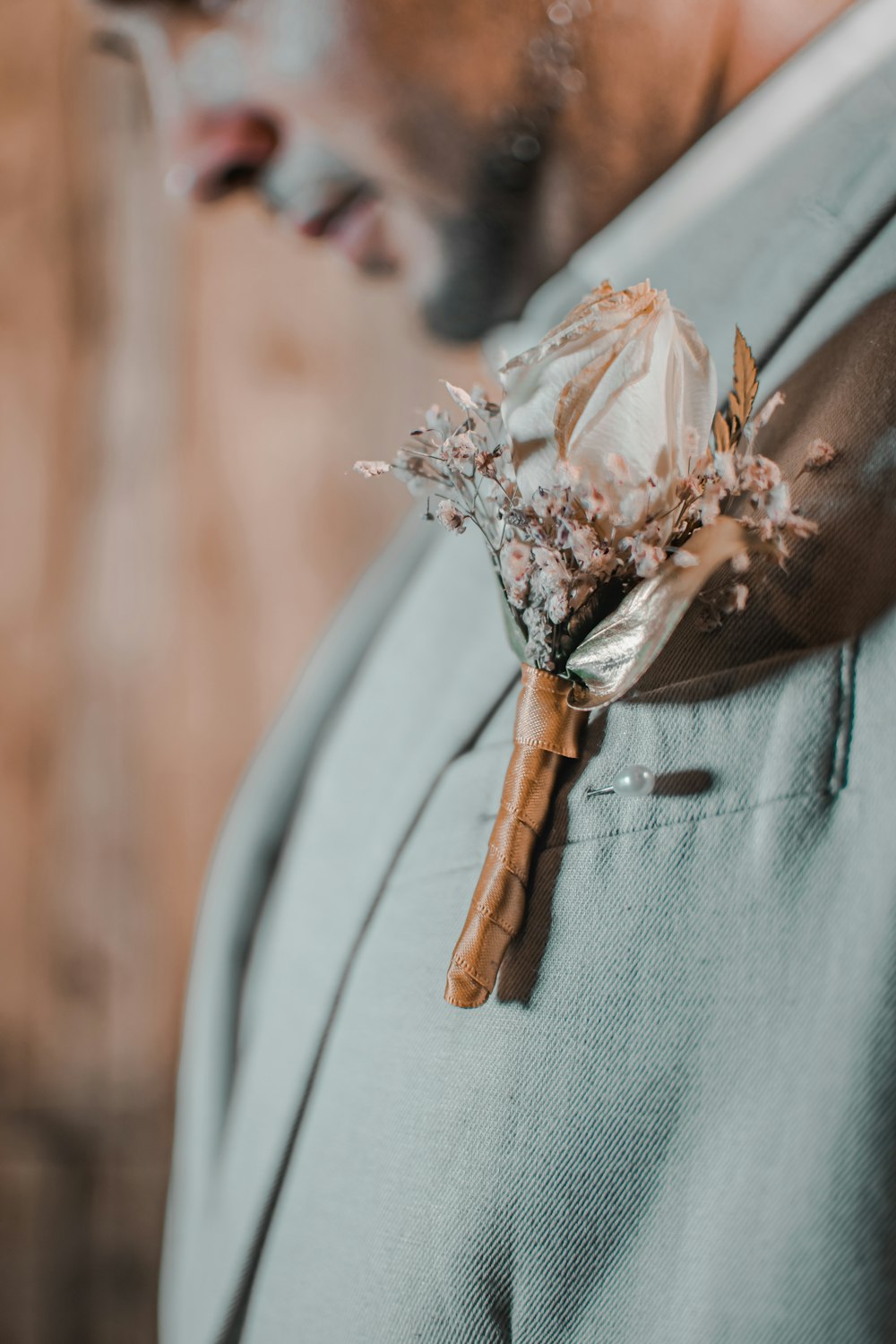 a man in a suit with a boutonniere on his lapel