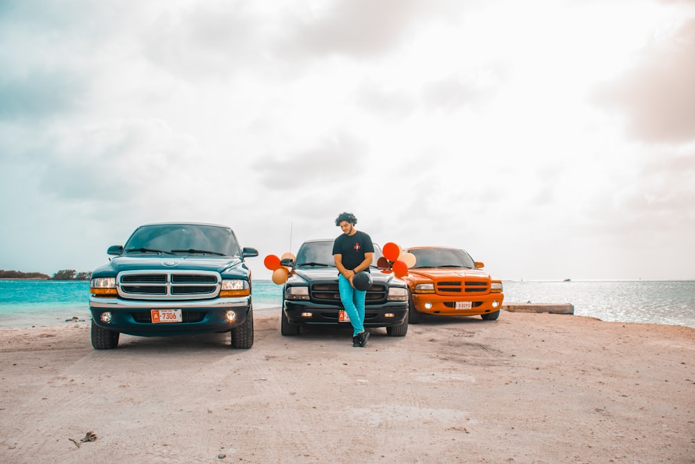 a man sitting on the hood of a pickup truck