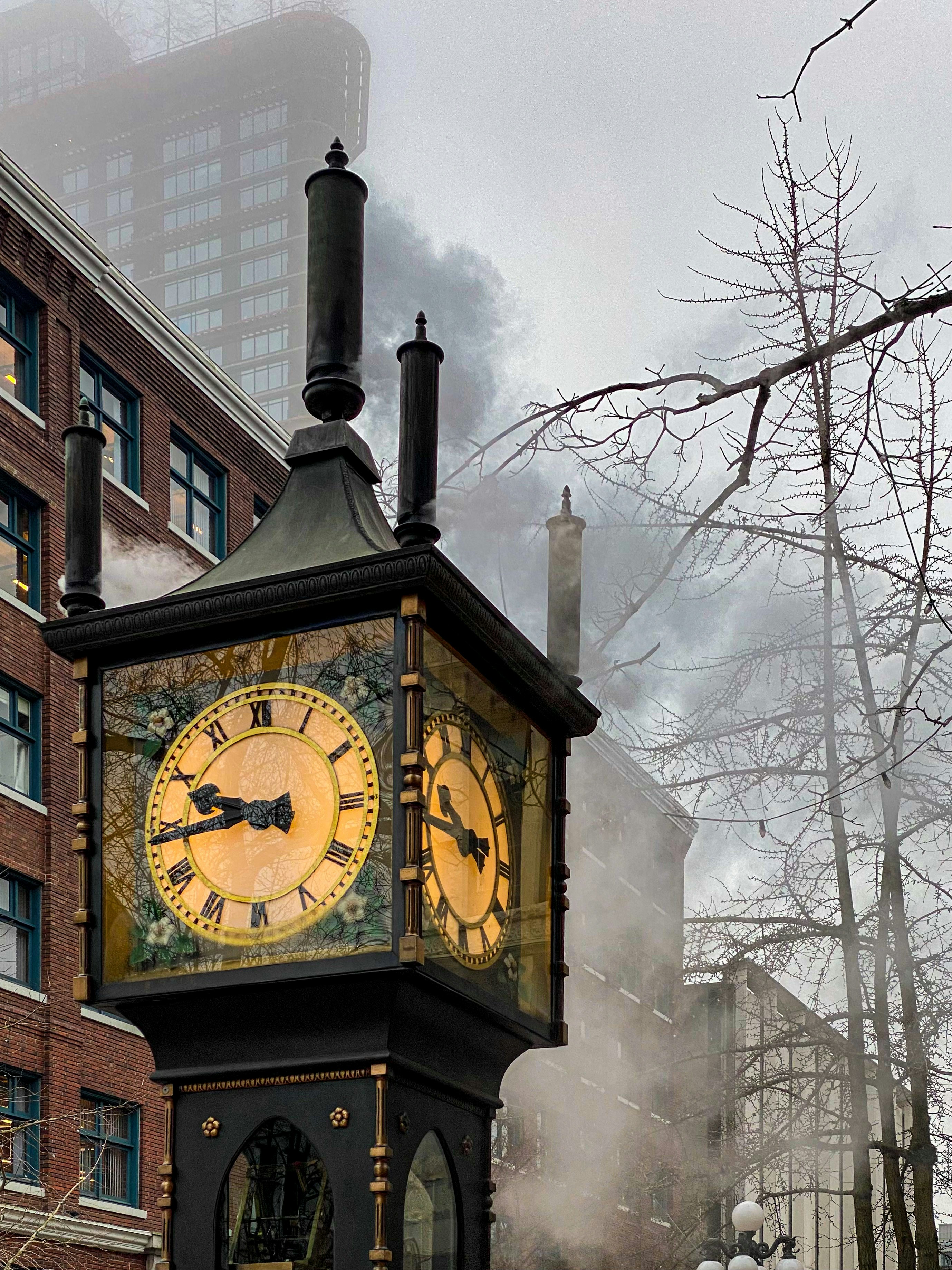 a clock tower with steam pouring out of it