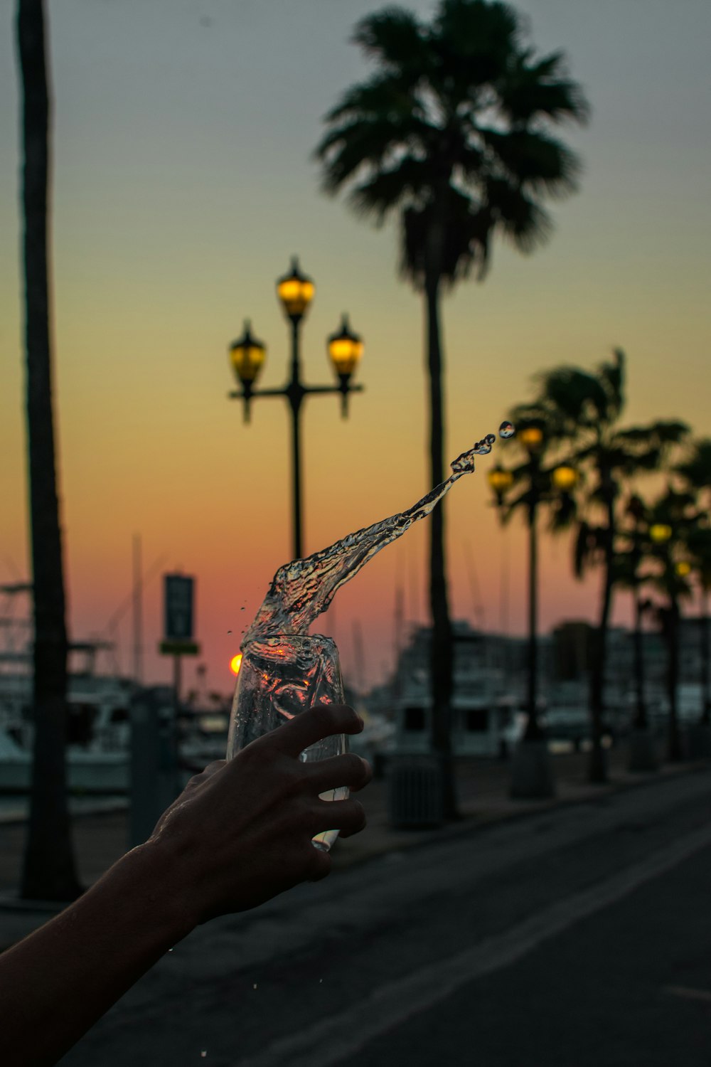 a person holding a glass with water in it