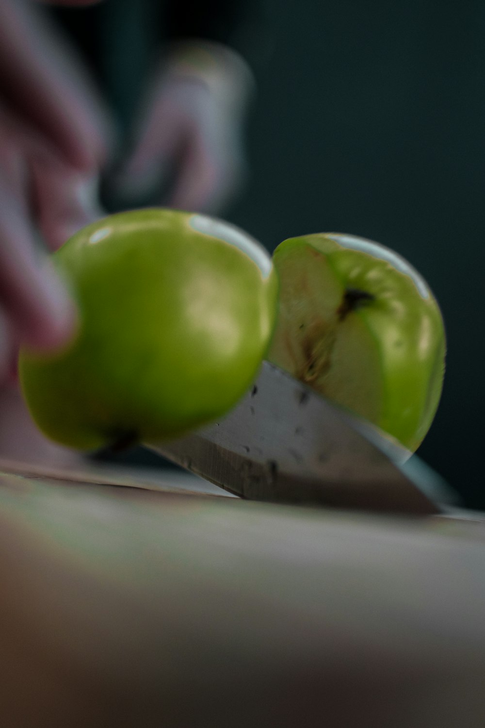a person cutting an apple with a knife
