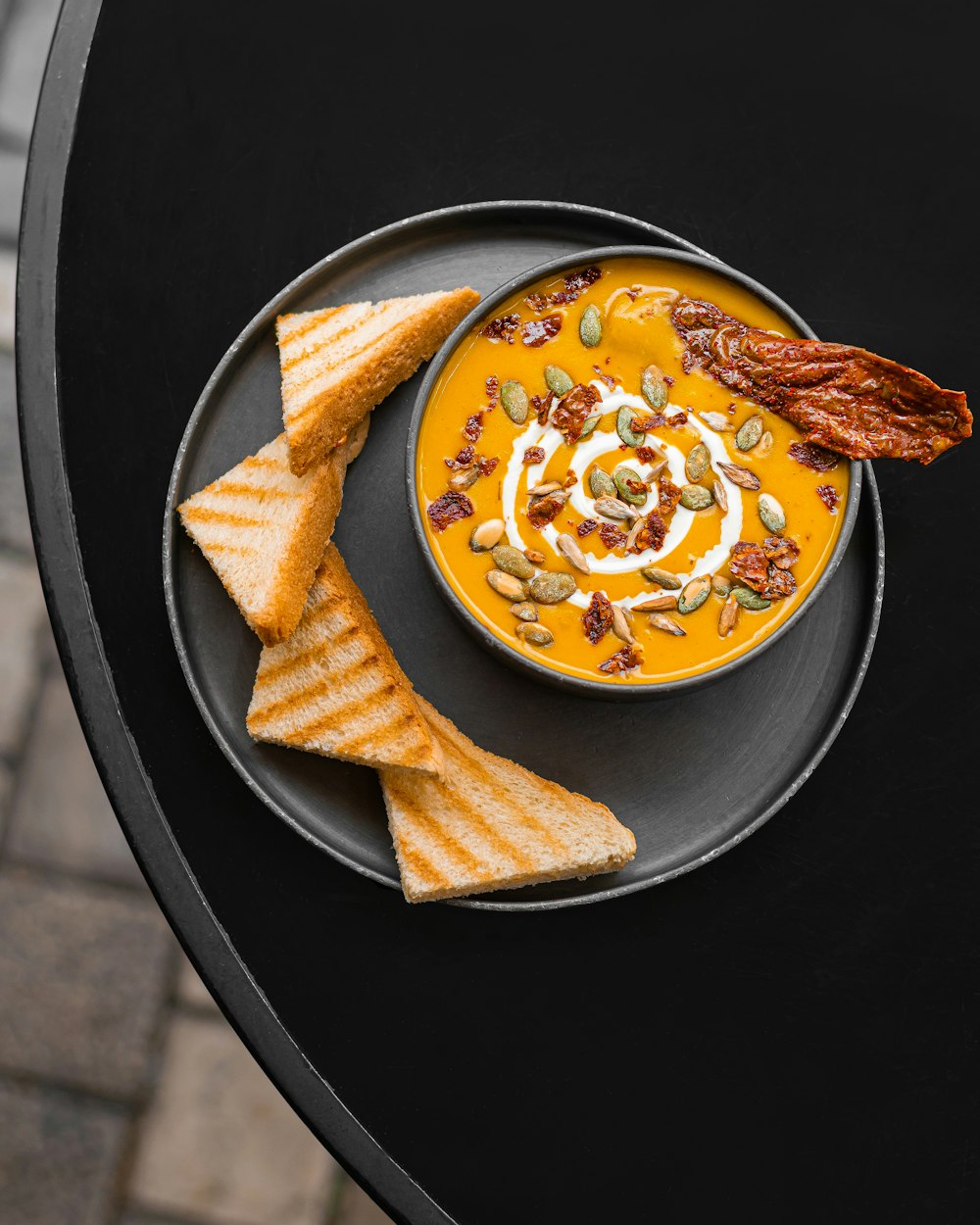 a plate of food with crackers and a bowl of soup