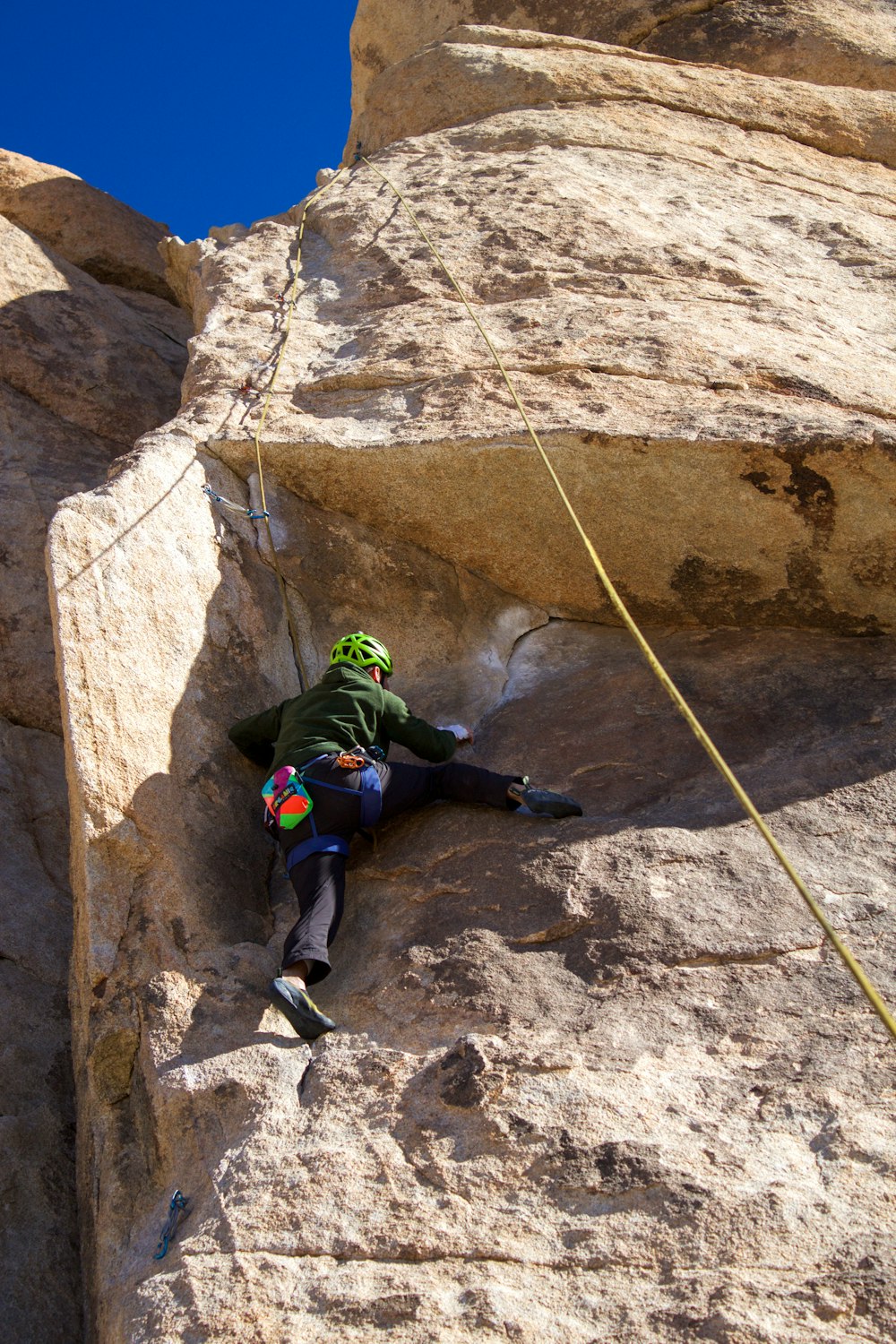 a man climbing up the side of a mountain