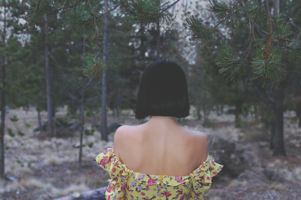 the back of a woman's head in a forest