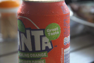 Close-up of a chilled lime soda bottle with condensation droplets and a slice of lime on the rim.