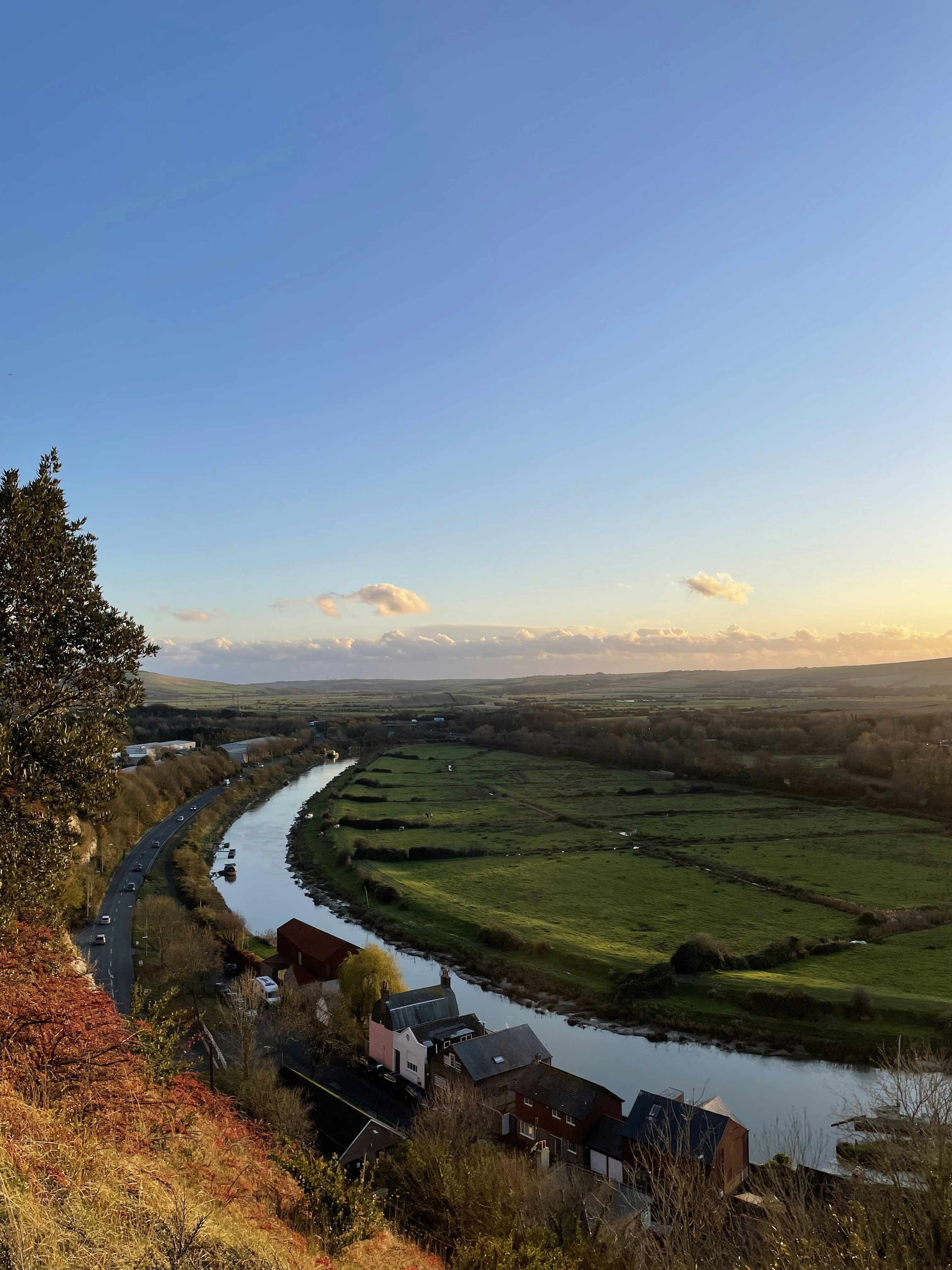 a river running through a lush green countryside