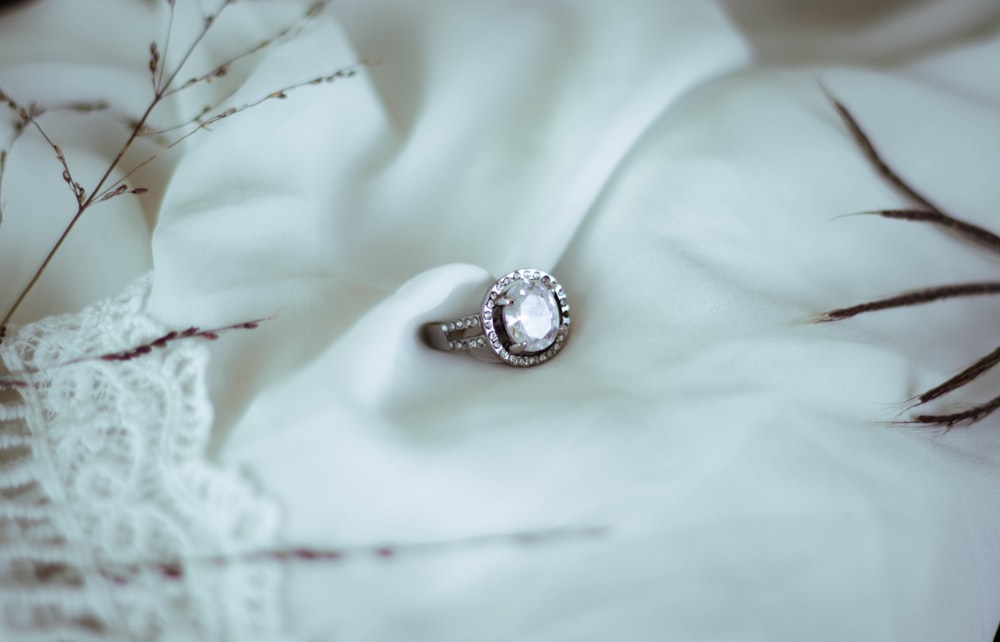 a close up of a ring on a white cloth