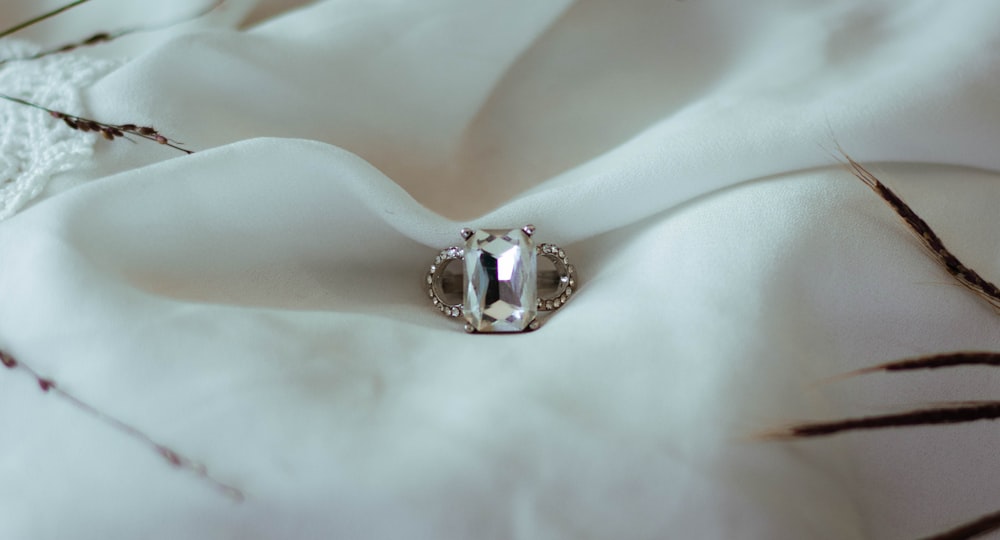 a close up of a ring on a white cloth