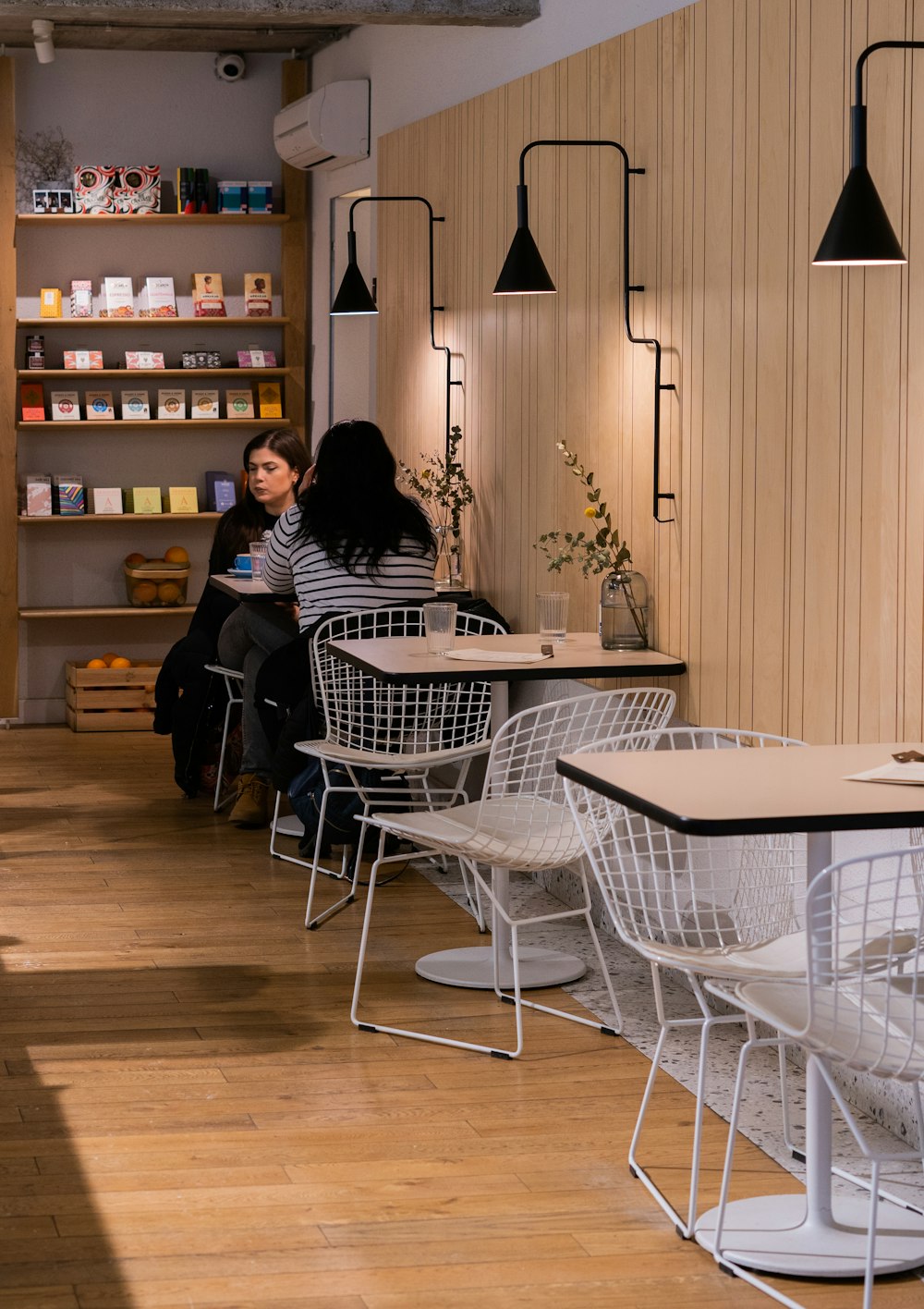 a woman sitting at a table in a coffee shop