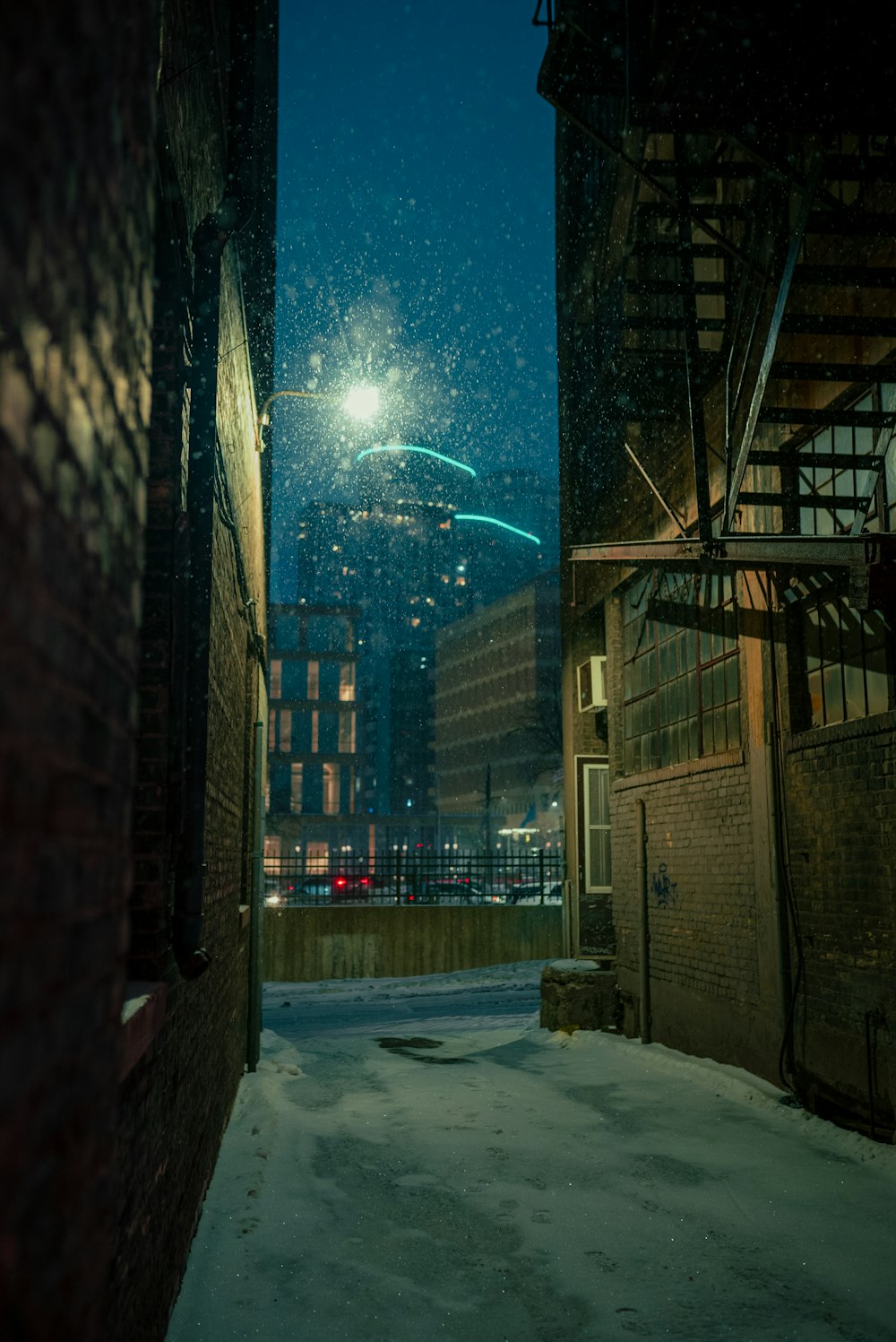 a city street at night with snow on the ground