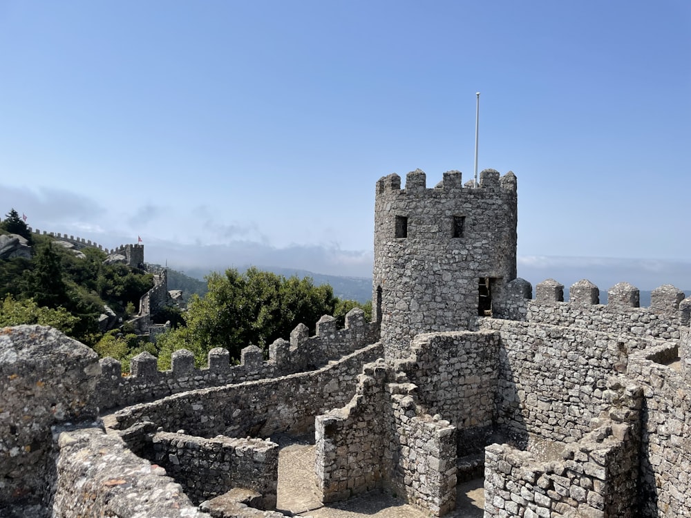 a stone castle with a flag on top of it