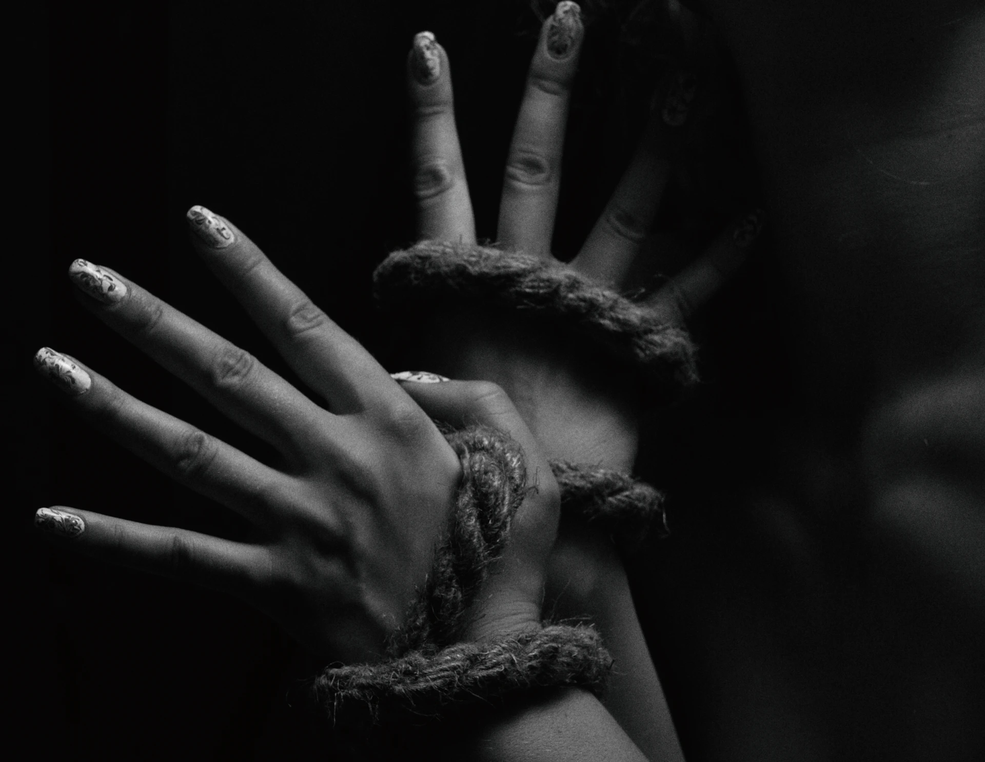 a woman's hands tied up with rope