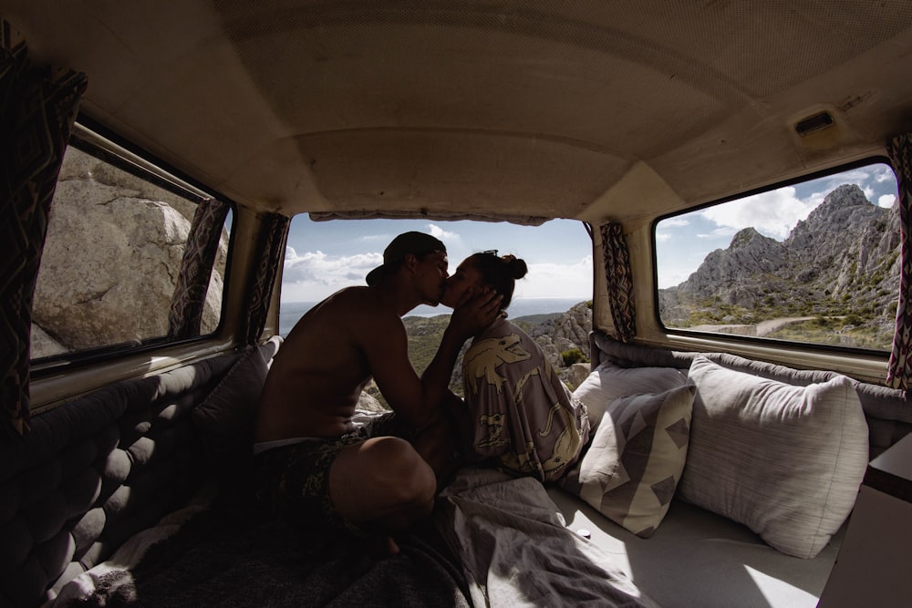 a man and woman kissing in the back of a van