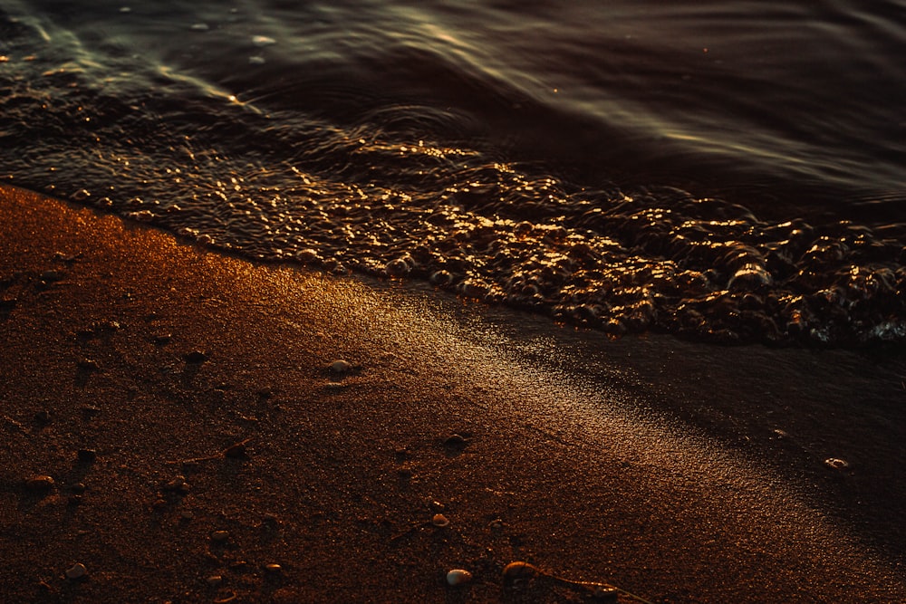 a close up of the sand and water on a beach