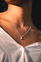a close up of a woman wearing a necklace