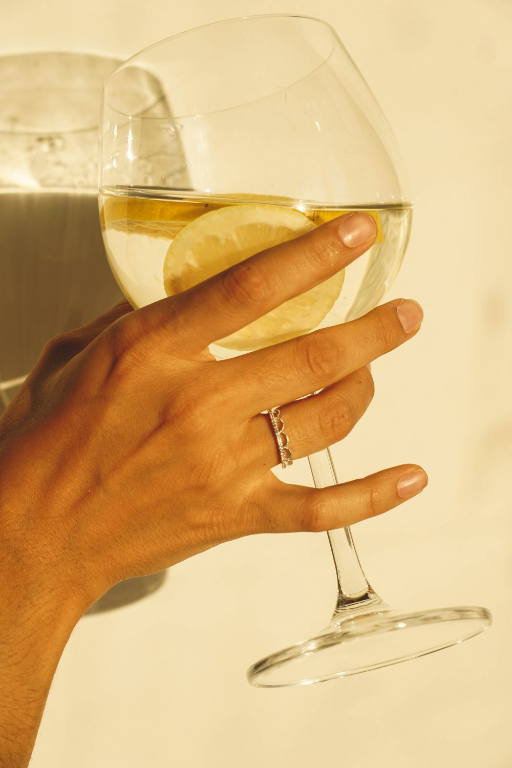 a woman's hand holding a glass of wine