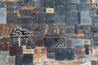 A collection of custom metal medallions and plaques displayed on a wooden surface.