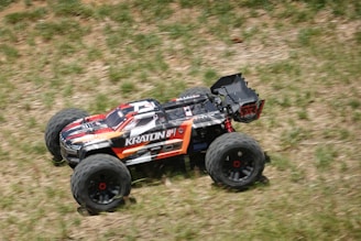 a remote controlled monster truck driving through a field