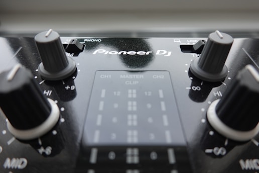 a close up of a sound board with knobs