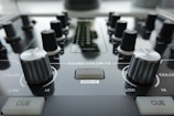 a close up of a sound board with knobs