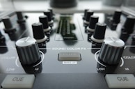 a close up of a sound board with knobs