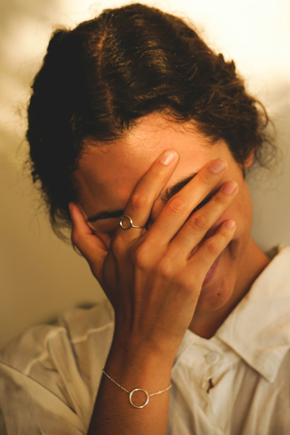 a woman covering her face with her hands