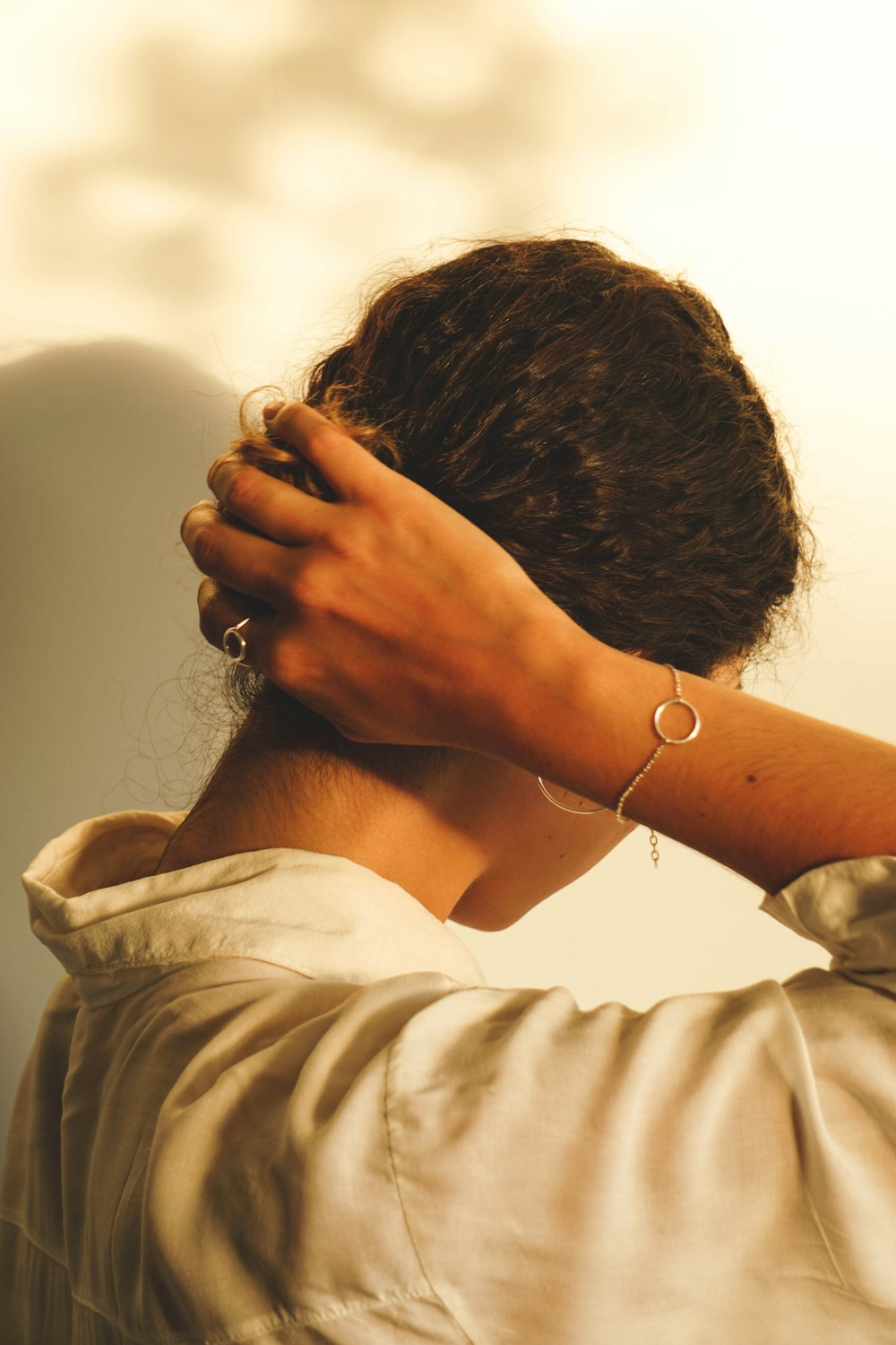 a woman with her hands on her head