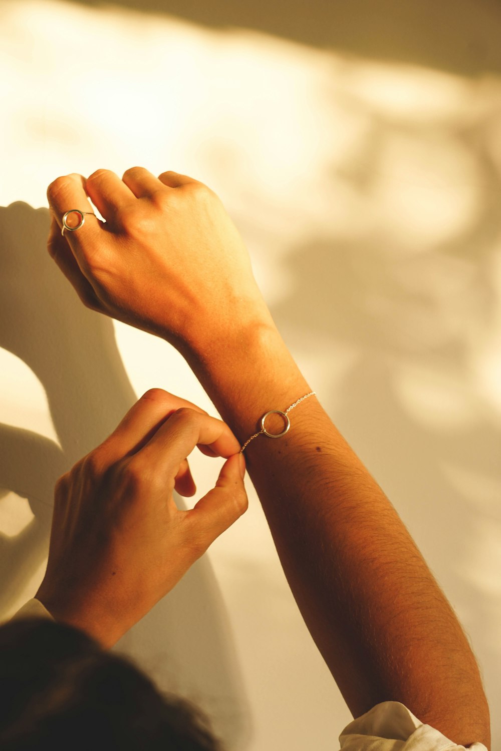 a woman is holding her hand up to her wrist