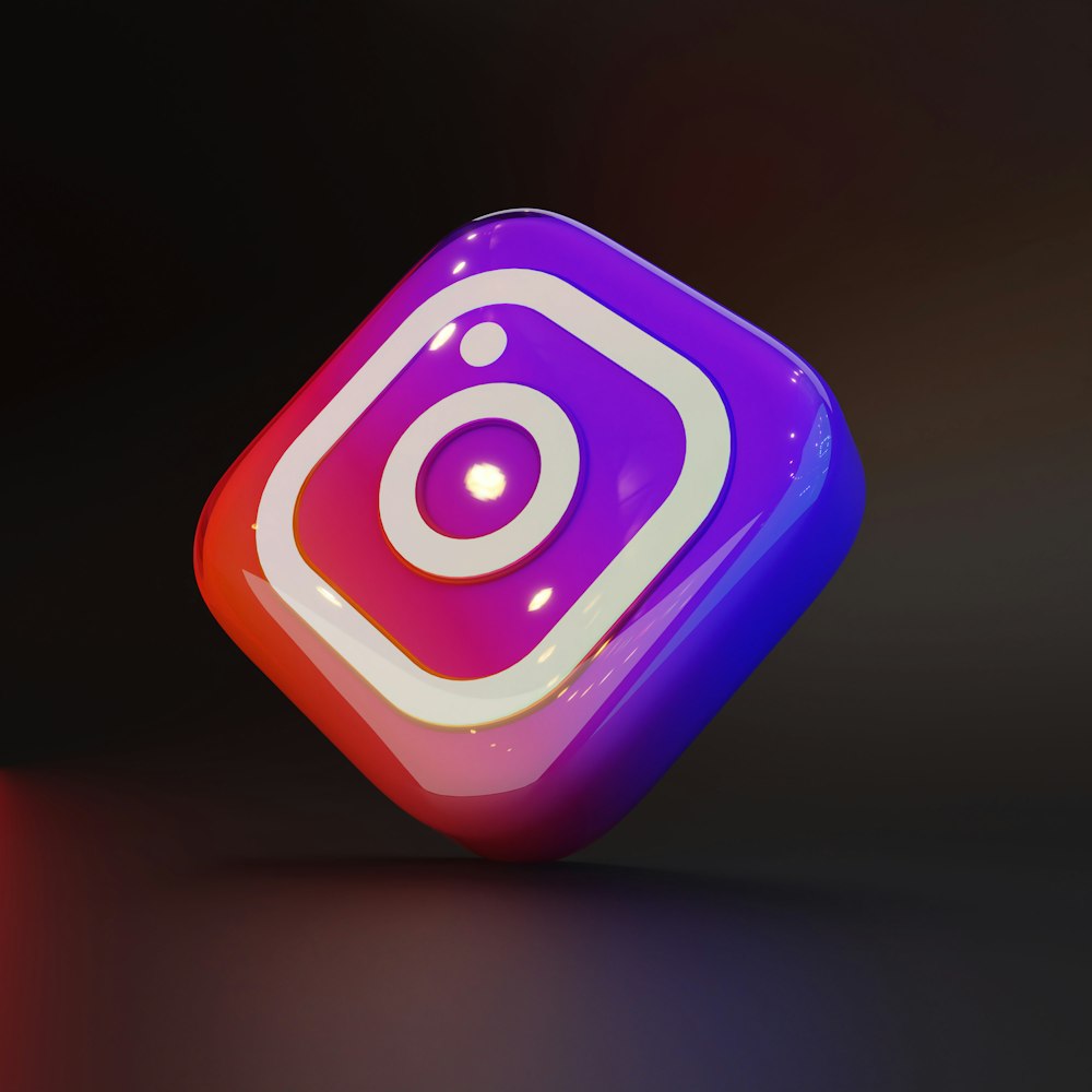 a purple and red instagram logo on a black background