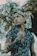 a man with tattoos standing in front of a tree