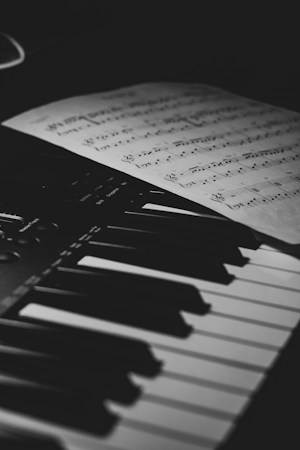 A piano keyboard with sheet music resting on the stand, representing the school music room piano that was tuned for free