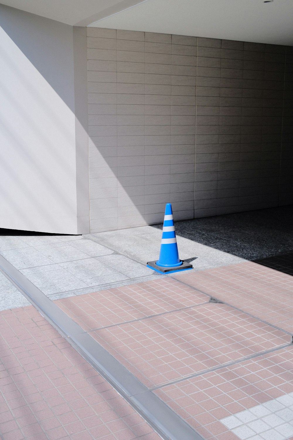 a blue and white cone sitting on top of a sidewalk
