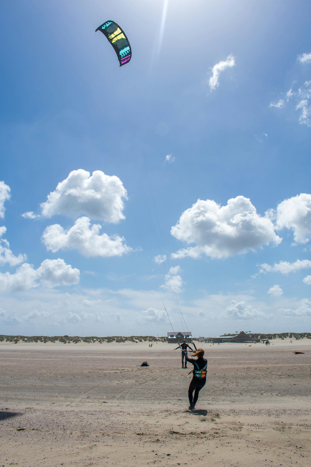 a person is flying a kite on the beach