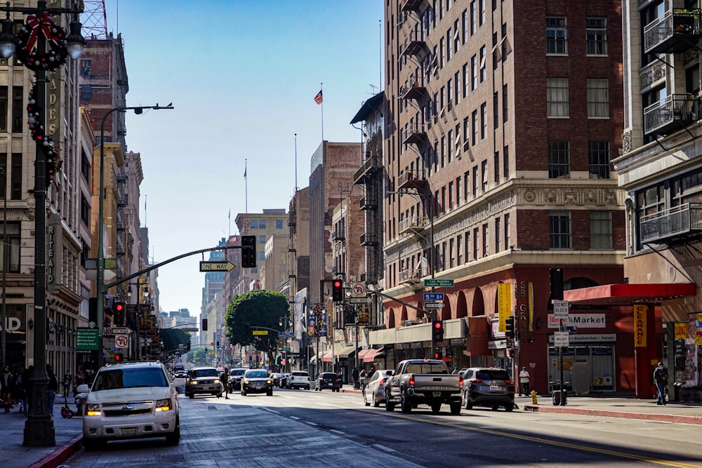 a city street filled with traffic next to tall buildings