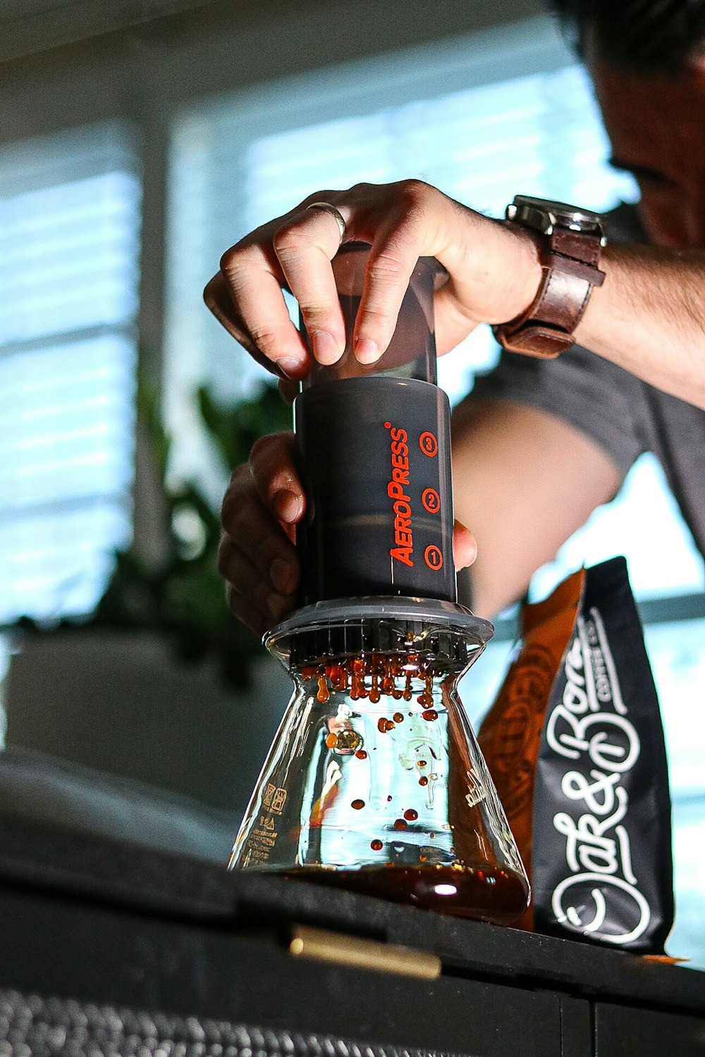 a man pouring a drink into a glass