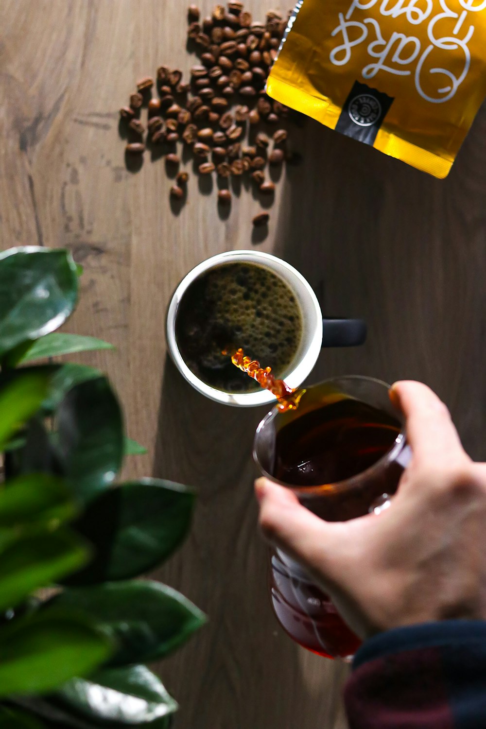 a person pours coffee into a cup