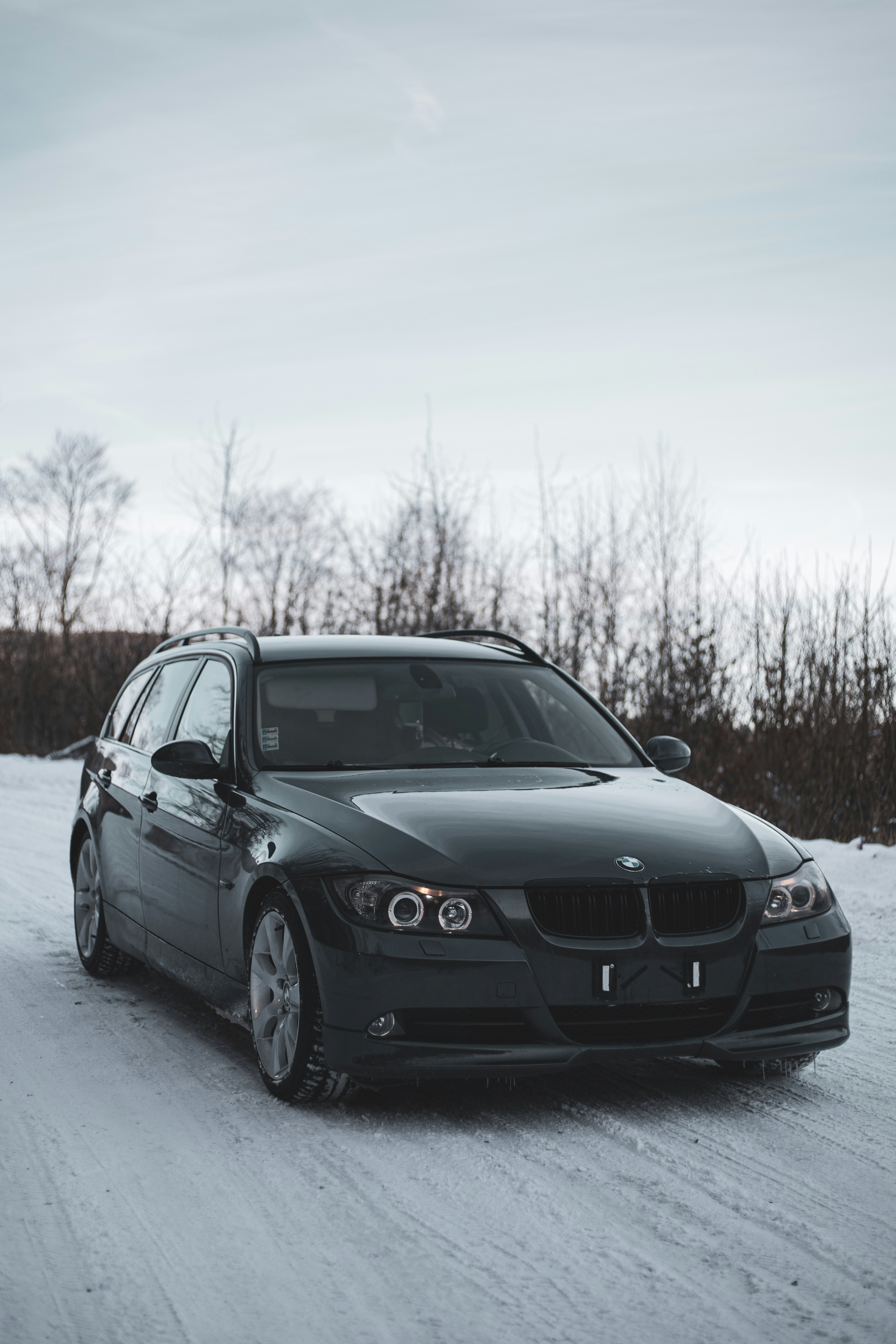 A black car driving down a snow covered road photo – Free Cabib Image ...
