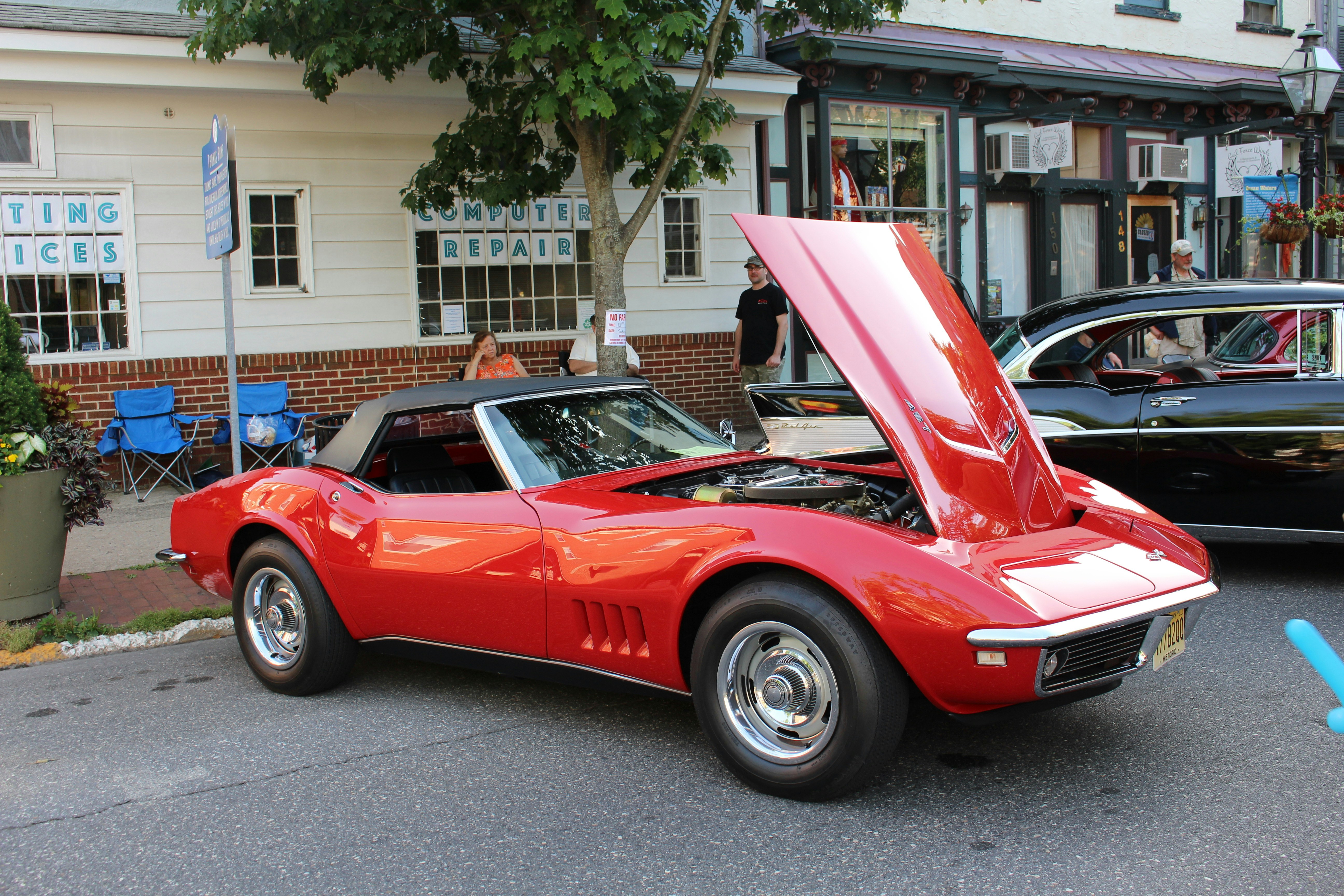 a red sports car with its hood open