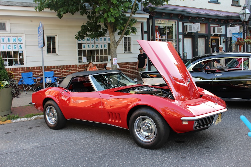 a red sports car with its hood open