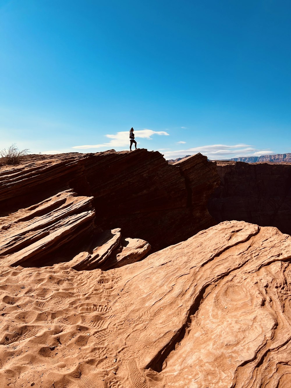 a person standing on top of a cliff