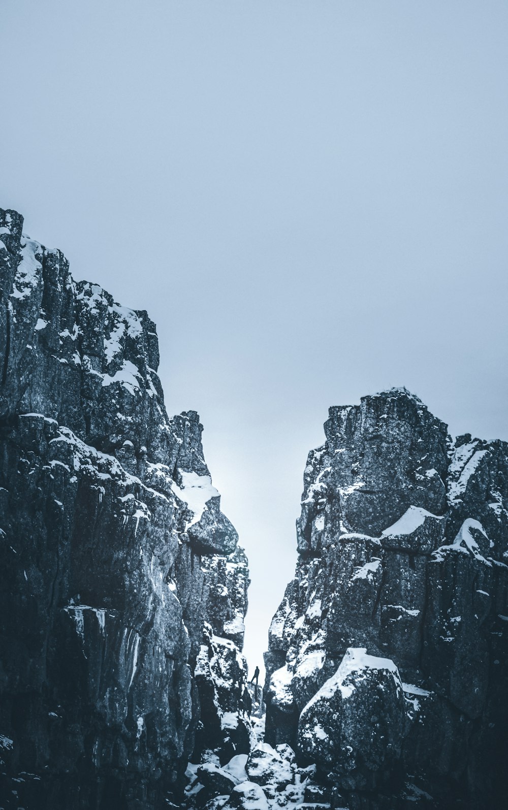 a couple of large rocks with snow on them