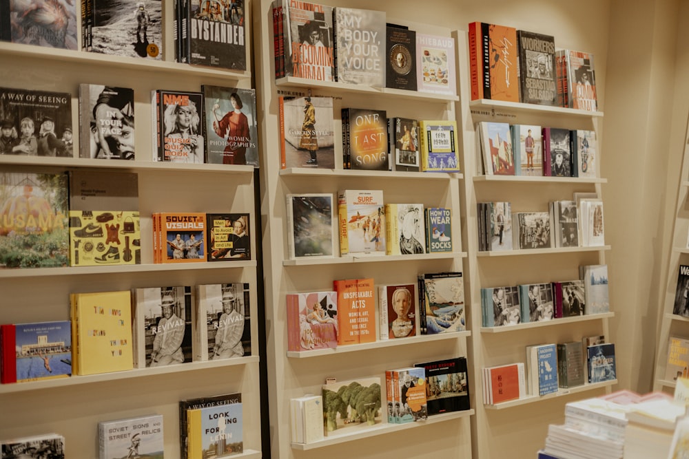 a bookshelf filled with lots of books next to a mirror