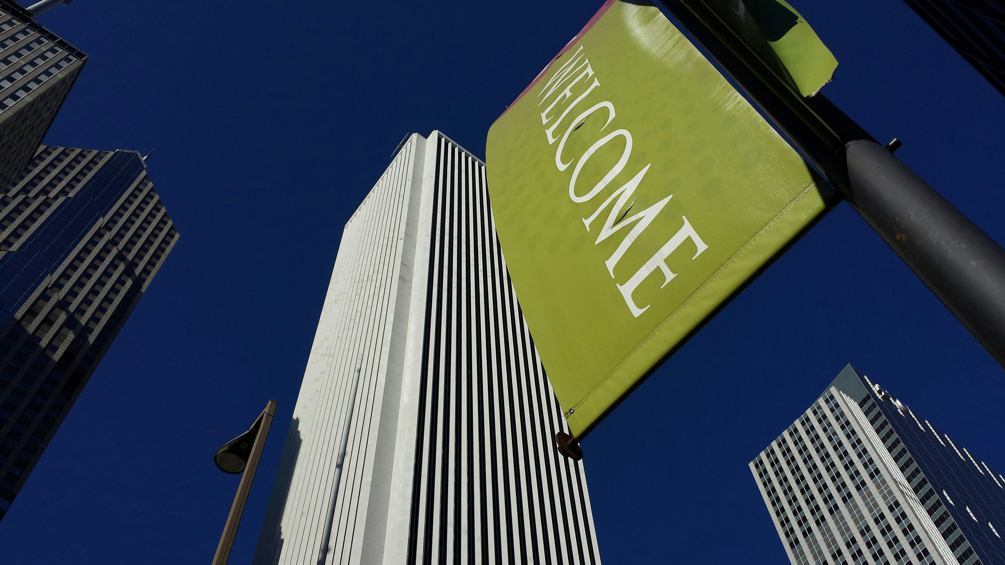 a street sign on a pole in front of tall buildings