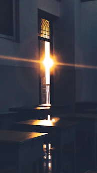 A bright sunrise behind a classroom window, symbolizing new beginnings in English teaching.