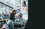 a woman cutting a man's hair in a barber shop