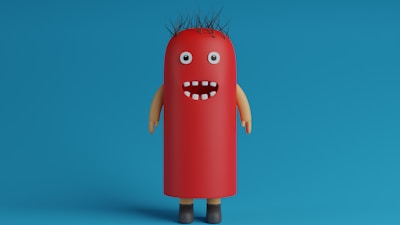 A whimsical, cartoonish character with a cylindrical, red body resembling a hot dog stands against a blue background. It has googly eyes, a wide open mouth with a few white teeth, spiky black hair, and tan-colored arms and brown shoes.