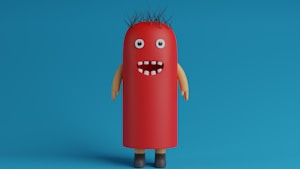 A whimsical, cartoonish character with a cylindrical, red body resembling a hot dog stands against a blue background. It has googly eyes, a wide open mouth with a few white teeth, spiky black hair, and tan-colored arms and brown shoes.