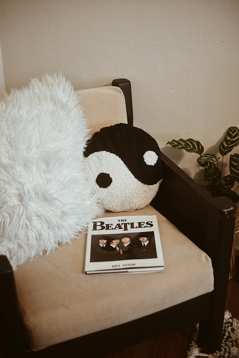 a stuffed animal sitting on top of a chair next to a magazine